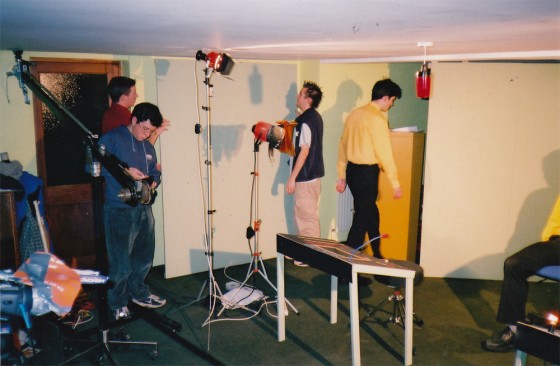 Actor Si Dovey (in red shirt) and I (in gillette, I regret to say) move a set panel into place while David Abbott adjusts the jib. Actor and composer Chris Jenkins, whose mother owned this basement, is in the yellow shirt.